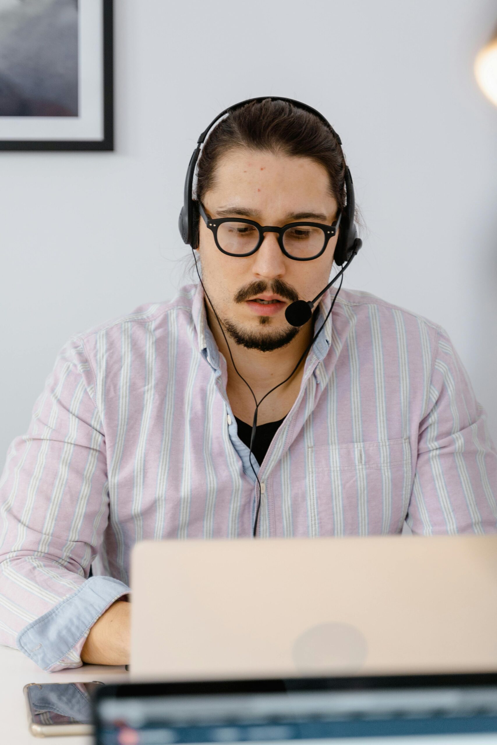 pexels photo 7709090 7709090 Professional customer support agent working remotely with headset and laptop, focusing on providing excellent service.